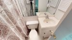 Bathroom with single sink basin and tub/shower combination